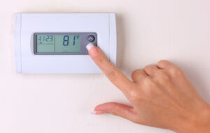 Woman Adjusting Thermostat